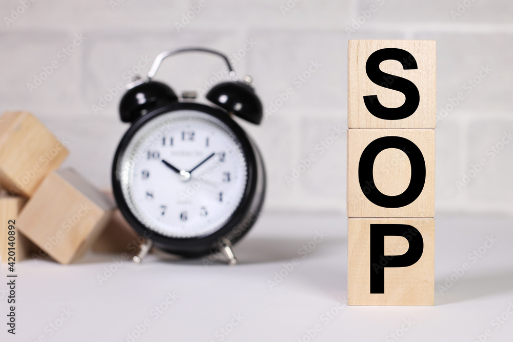Poster sop as standard operating procedure conceptual image. text on wood cubes. text in black letters on w