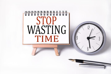 Stop wasting time.Text on white notepad paper on light background