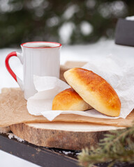 a cup of hot drink and russian pies
