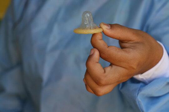 woman with male condom in hand 2021
