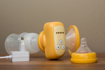 breast pump yellow on a wooden table