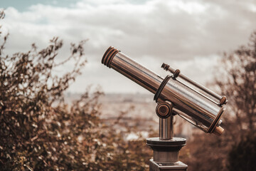 Paris, France 13-03-2021: mini telescope for a view of Paris during rainy day