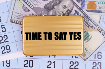 On the table lies a calendar, money and a briefcase with the inscription - TIME TO SAY YES