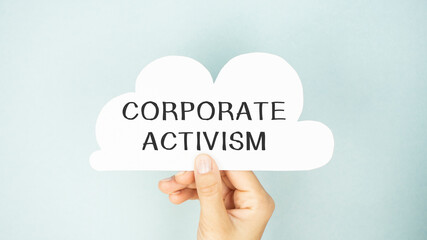 CORPORATE ACTIVISM text on paper in the form of a cloud in hand.