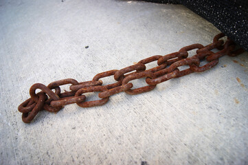 Old worn chain on ground
