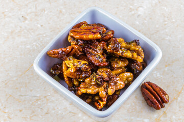 Roasted walnuts and pecan nuts in white pot