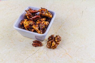 Roasted walnuts and pecan nuts in white pot