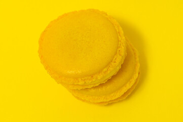 Yellow macaroons on yellow background