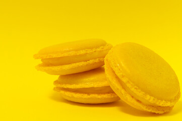 Yellow macaroons on yellow background