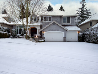 Curb view of a home with freshly fallen snow during early winter season
