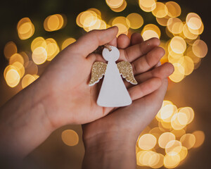 hand holding christmas angel
