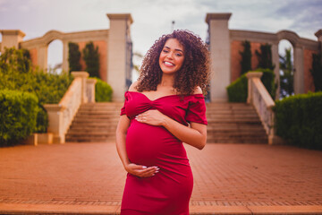 Beautiful pregnant Afro woman, posing for photo in an external rehearsal showing her pregnancy...
