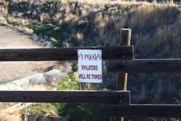 No Parking Sign on Wooden Fence
