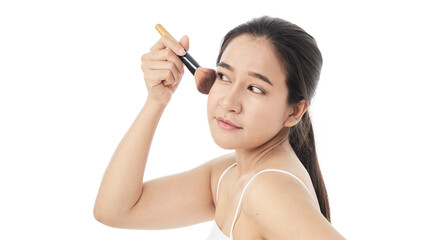 woman applying make up with a brush