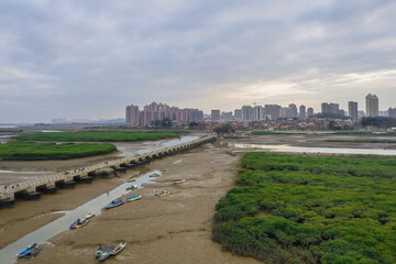 Fototapeta na wymiar Aerial view of the sunset landscapes and city skyline at Luoyang Bridge, Quanzhou, China. Luoyang Bridge is the first stone bay bridge in China