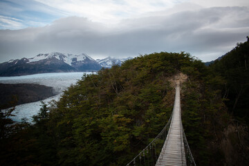 A bridge at the mountains, in front of a glaciar