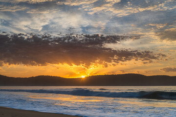 Fototapeta na wymiar Sunrise seascape at the beach with haze and cloud
