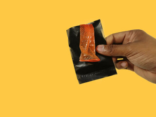 Condom disposal sachet used after sex for dispose off Condom, hand holding and keeping inside...