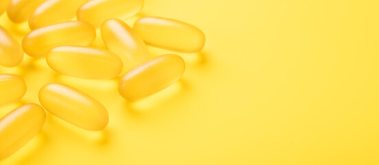 Close up Omega 3 capsules on yellow background. Fish oil softgels. Copy space for your text. Banner - Image