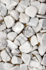 White turquoise jewel heap on light wood texture. Pile mineral pebbles background.