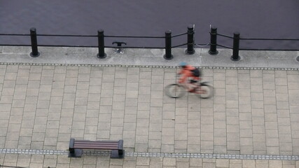 Blurred cyclist on stone pavement