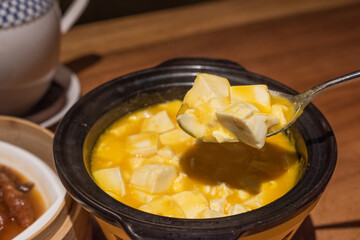 Spoon up the bean curd with crab roe