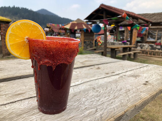 Dark beer prepared with bittersweet chili in plastic glass, very common in Mexico. Michelada