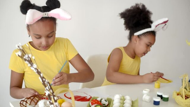 sisters coloring and designing eggs for ester