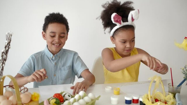 children playing together and coloring their eggs on ester 