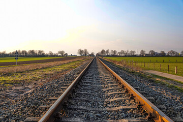 empty railroad between the fields