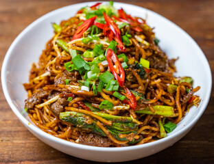 Malaysian popular dish stir fried noodles or locally known as Mee Goreng. Selective focus.