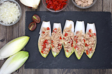 Endives filled with tuna, red pepper and onion seen from above
