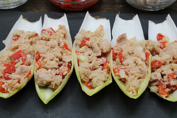 Endives dish filled with tuna, red pepper and onion 