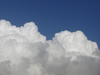Fluffy white clouds against a blue sky