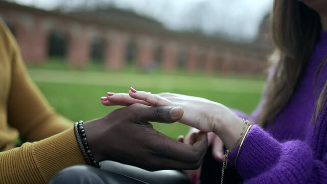Close-up interracial hands caress and love