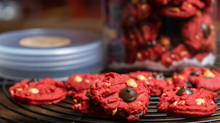 Freshly baked red velvet cookies on cooling rack. Selective focus.
