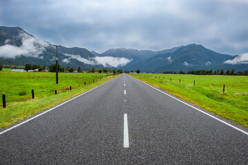 Highway running through farmland. South Island, New Zealand.