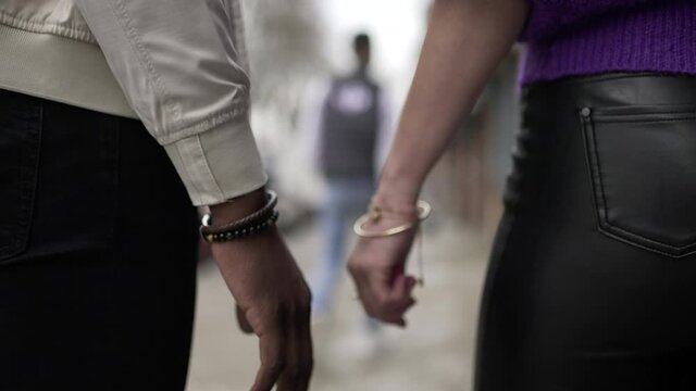 Couple disjoining hands, lovers separating