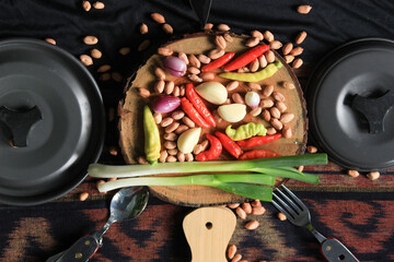 pans, knives, cooking utensils and kitchen ingredients such as chilies, shallots, garlic, peanut,...