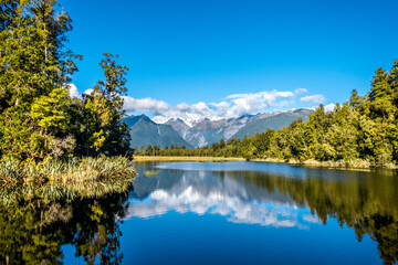 The Southern Alps reflecting in Matheson Lake. South Island, New Zealand.
