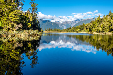 Fototapeta na wymiar The Southern Alps reflecting in Matheson Lake. South Island, New Zealand.