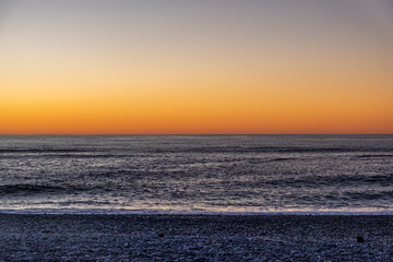 Ocean beach at sunset. South Island, New Zealand.