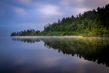 Fototapeta na wymiar Morning fog over a beautiful lake. South Island, New Zealand.