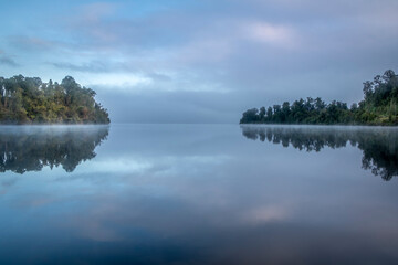 Morning fog over a beautiful lake. South Island, New Zealand.