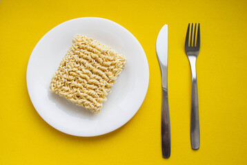 Noodles on a plate. Vermicelli in the shape of a square on a round plate.