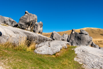 Rock formation in the middle of alpine grassland. South Island, New Zealand.
