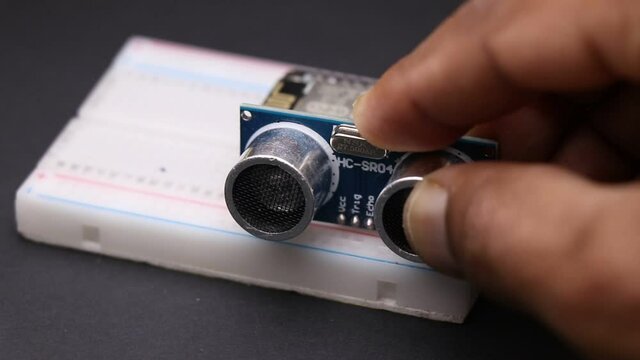 Ultrasonic sensor which is distance measuring sensor connecting to breadboard showing DIY Projects concept