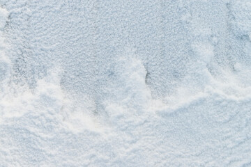 Snowy background. View from top. Snow crystals cover the boards, a figured snowdrift. Concept for Christmas, New Year.