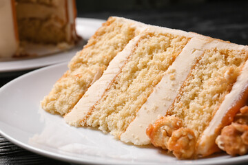 Plate with piece of tasty cake on table, closeup