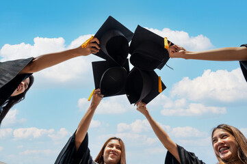 graduates student Graduation caps thrown in the Air Blue sky